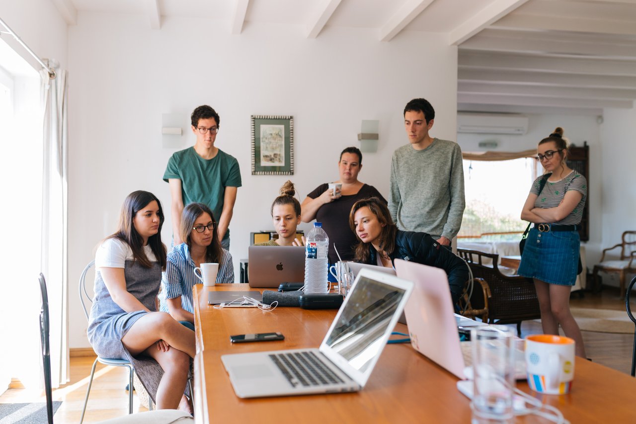 colleagues watching a presentation on a laptop at work
