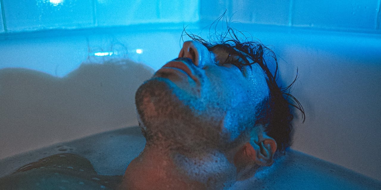 a dark blue brain surround by flashes of color to symbolize overstimulation or sensory overload in ADHD and sensory processing issues