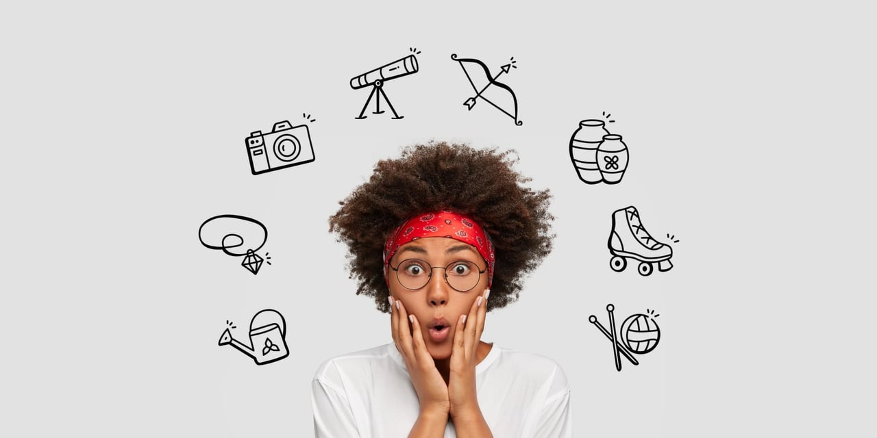 Multitude of hobby representations on the same shelf including an electric guitar, cameras, and knitting needles.