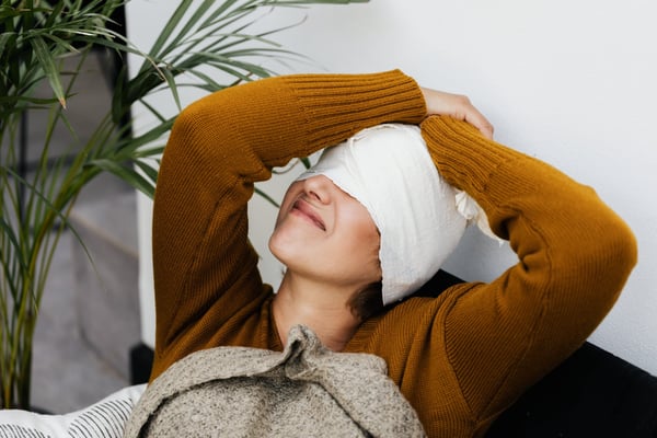 A traumatic brain injury (TBI) typically occurs when the head suddenly striking an object or when an object pierces the skull and brain tissue. Image shows a woman with a bandage wrapped around her head.