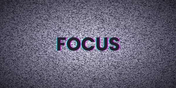 an old tv with static, on the screen is the word focus