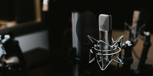 a microphone that's labeled "podcast". in the background, adhd in letters