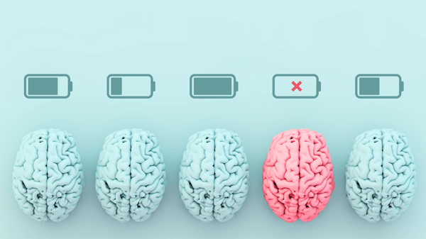A photo of 5 brains lined up. All are blue except the fourth one, which is pink. The brains all have a battery icon above them at various levels of charge. The pink brain is the only dead battery, which symbolizes the person with ADHD experiencing social exhaustion.