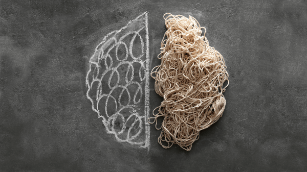 A chalkboard background with a drawing of a brain on the left side. The right side of the brain is made out of jumbled string.