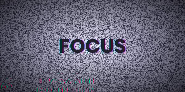 an old tv with static, on the screen is the word focus