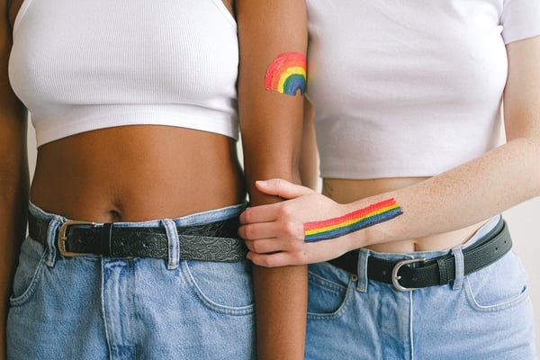 two women's torso with gay pride body paint