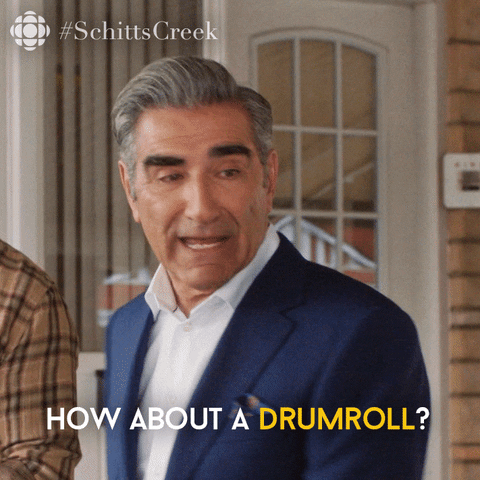 gif of the dad from Schitt's Creek saying "how about a drumroll?"