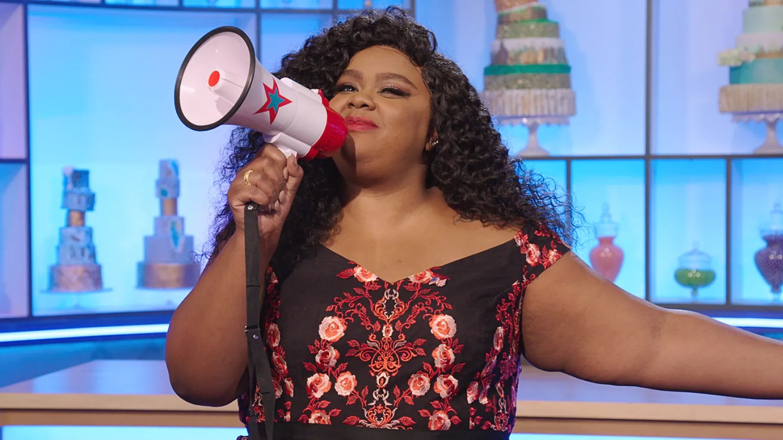 nicole byer with a megaphone on the set of nailed it!