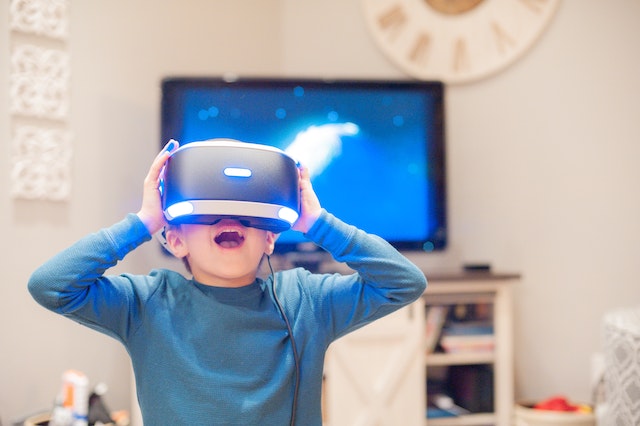 a child with a vr headset on, questioning if video games and screens cause adhd in children
