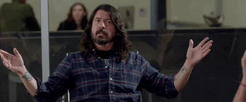 Gif of Dave Grohl from the Foo Fighters, tapping with both hands on his temples and saying It's all in here.