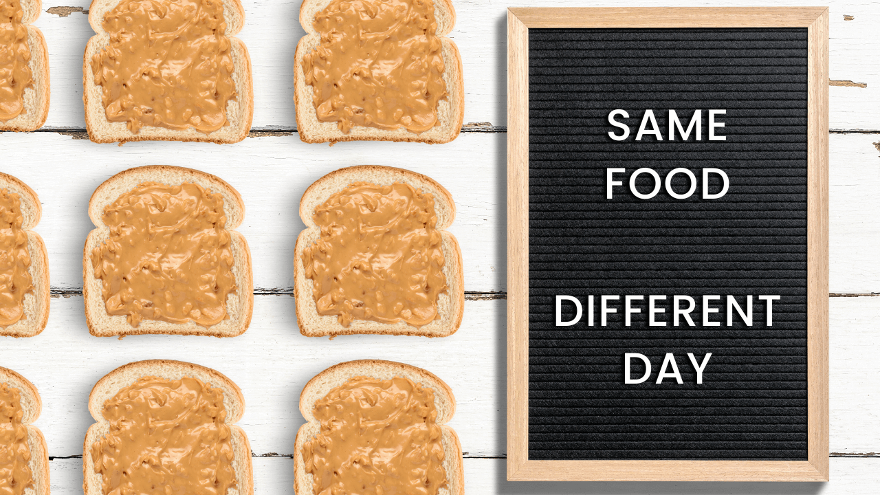 A letter board sign that says, same food different day. There are pieces of bread with peanut butter on them lined up next to the sign.