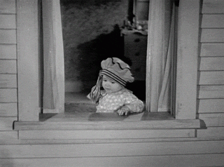Black and white gif of a toddler throwing bundles of banknotes out of the window.