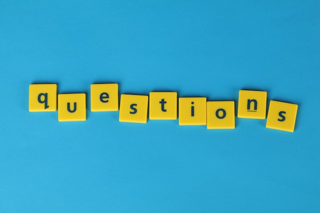 bright blue background with yellow tiles that spell the word: questions