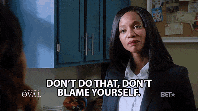 Gif: A Black woman in a dark business suit and white button-down shirt is speaking to someone opposite her. Only part of the other person's head is visible from behind. They have long brown hair. The woman in the suit is shaking her head, furrowing her eyebrows in concern, and saying: Don't do that, don't blame yourself.