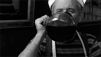 Movie gif. Black-and-white scene of Bill Murray wearing a paper hat and apron, drinking straight out of a coffee pot.