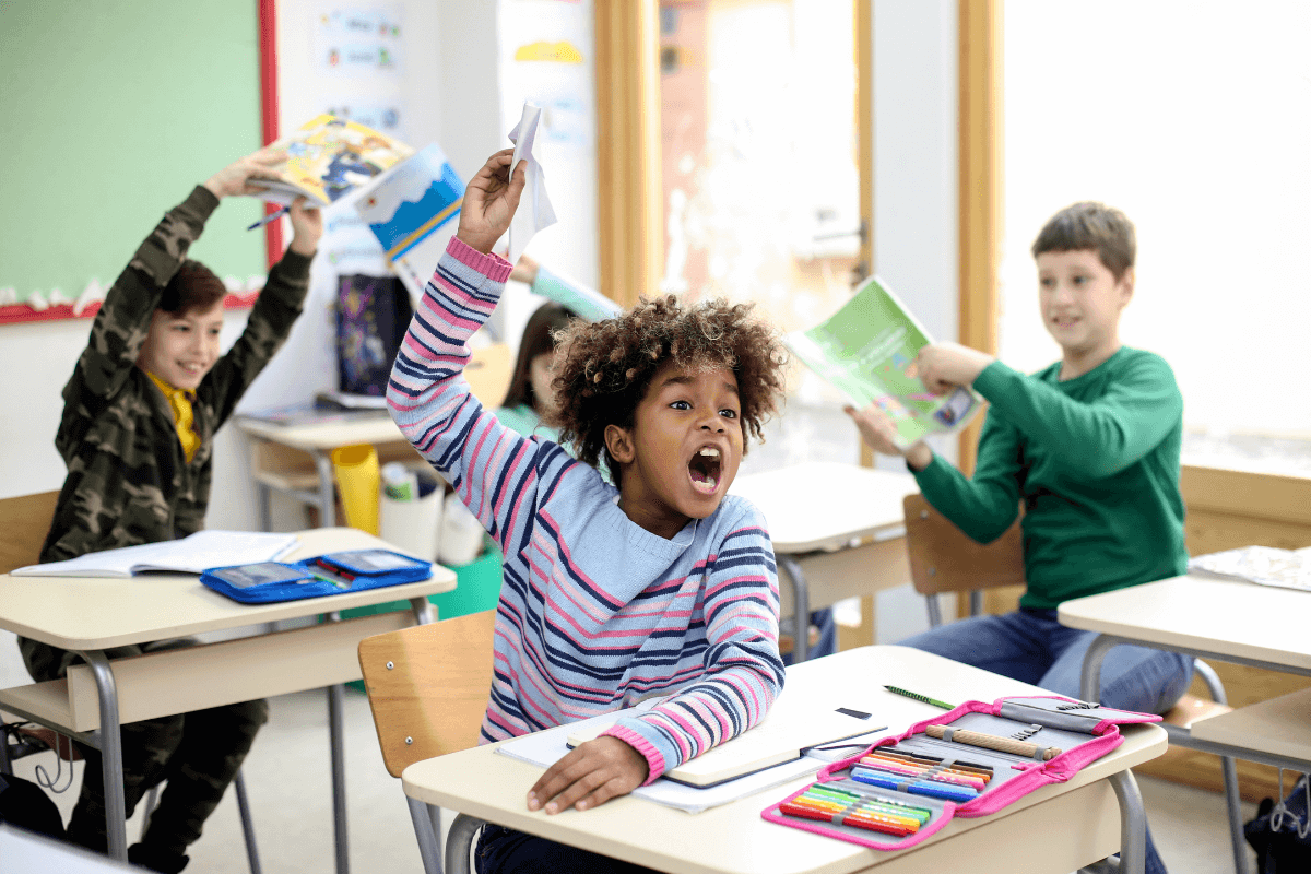ADHD children in a classroom are yelling and waving books around in the air, disrupting their class and teacher.