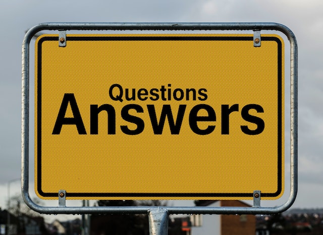 a big yellow sign that reads "questions andswers"